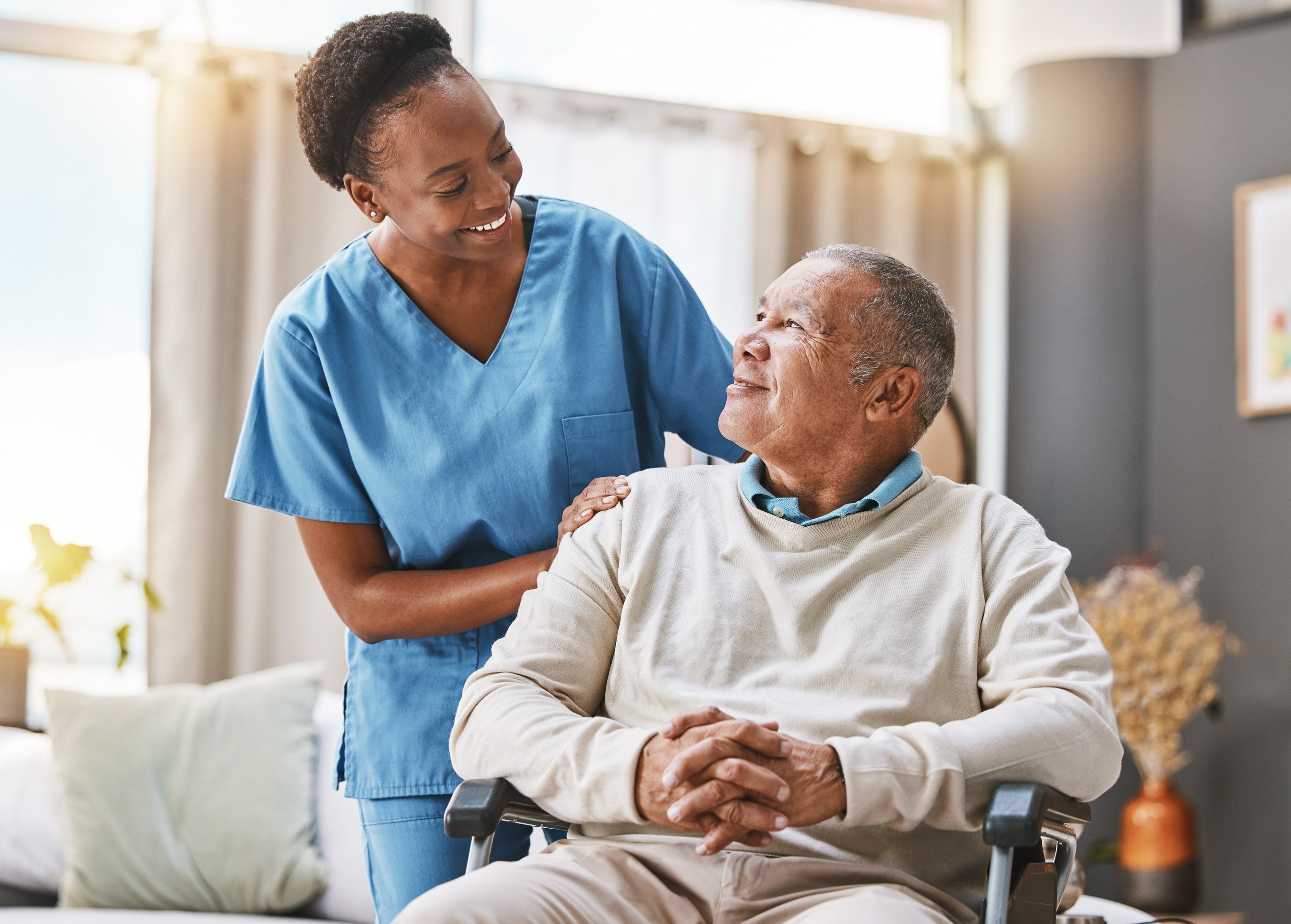 A Carealth carer supporting an elderly client at home